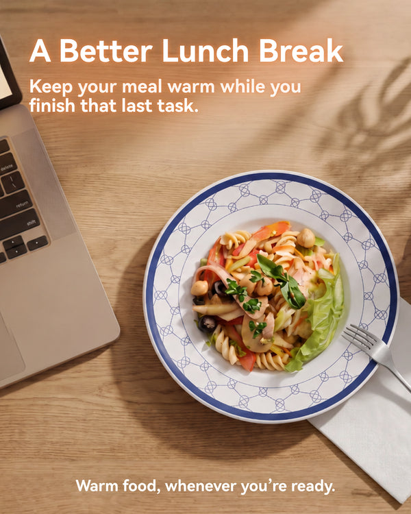 Pasta lunch on a blue MiaoLab thermostatic porcelain plate beside a laptop